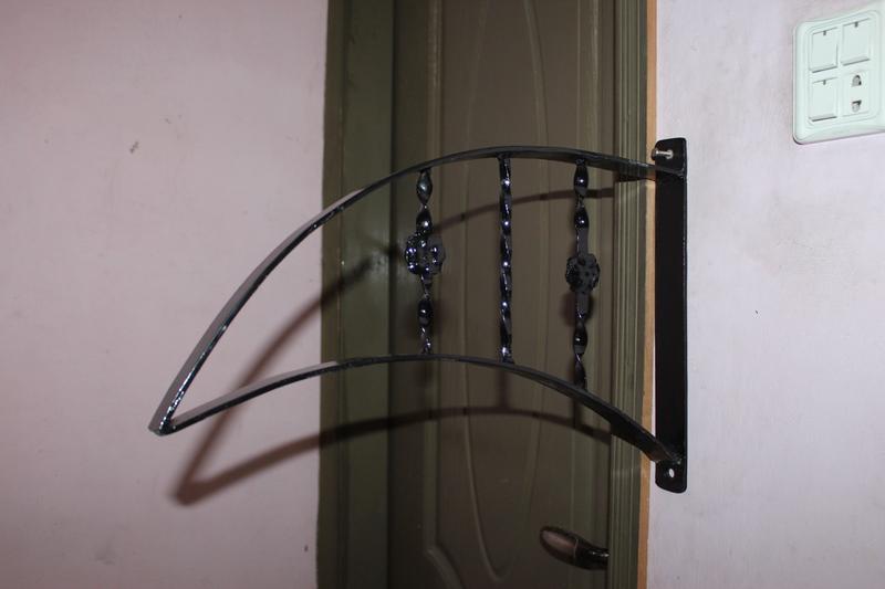 Ornate black scroll handrail detail showing decorative ironwork